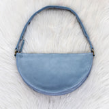 Blue handbag on a white fur surface