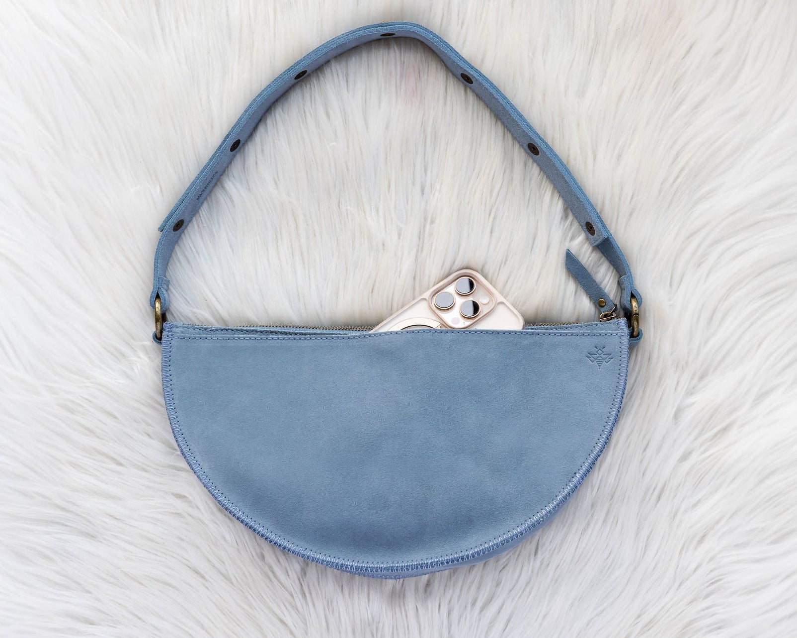 Blue handbag on a white textured surface