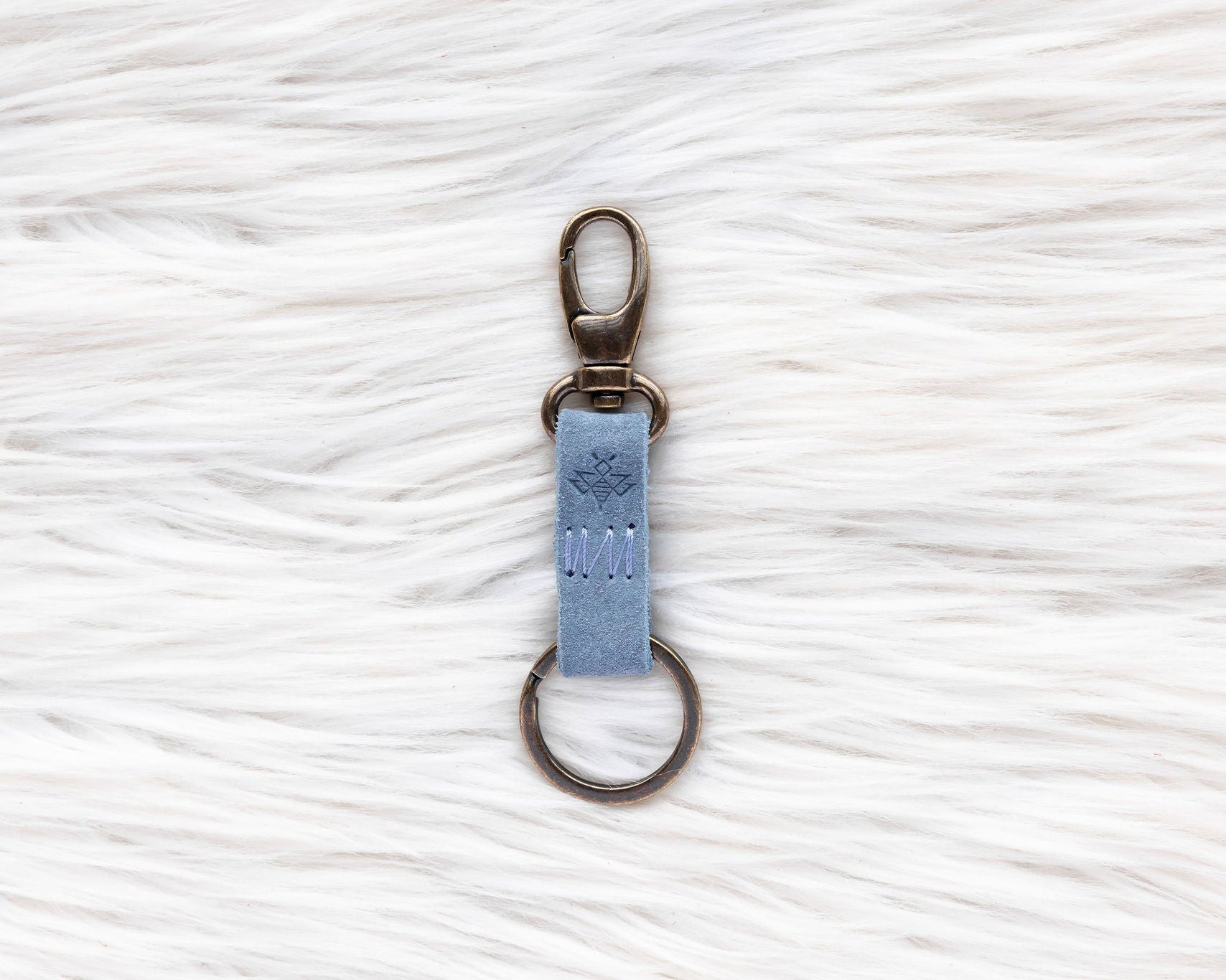Keychain with a blue tag on a white textured background