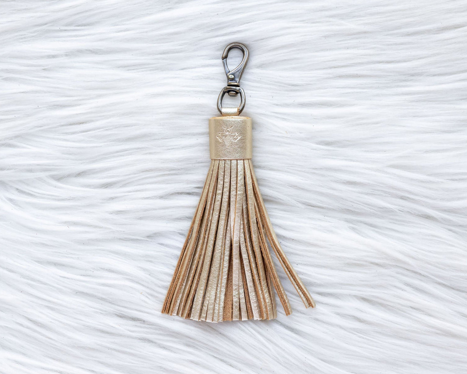 Tassel keychain on a textured white surface