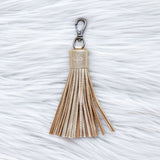 Tassel keychain on a textured white surface