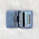 Blue cardholder with cards on a white textured surface