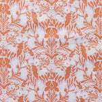 Patterned fabric with orange floral design on a light background