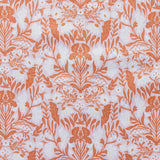 Patterned fabric with orange floral design on a light background