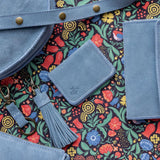 Blue leather bags with a colorful floral pattern background