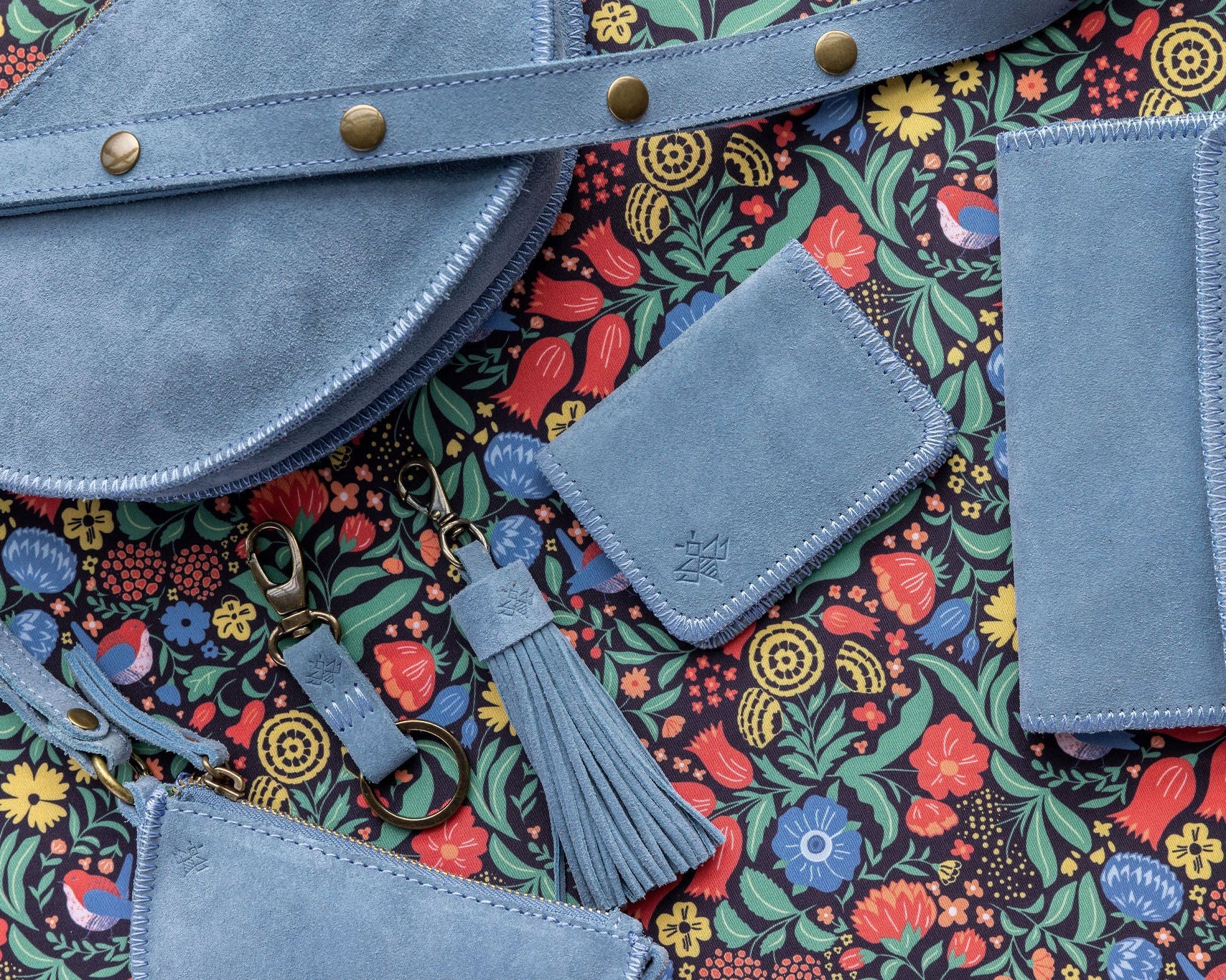 Blue leather bags with a colorful floral pattern background