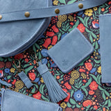 Blue leather bags with a colorful floral pattern background
