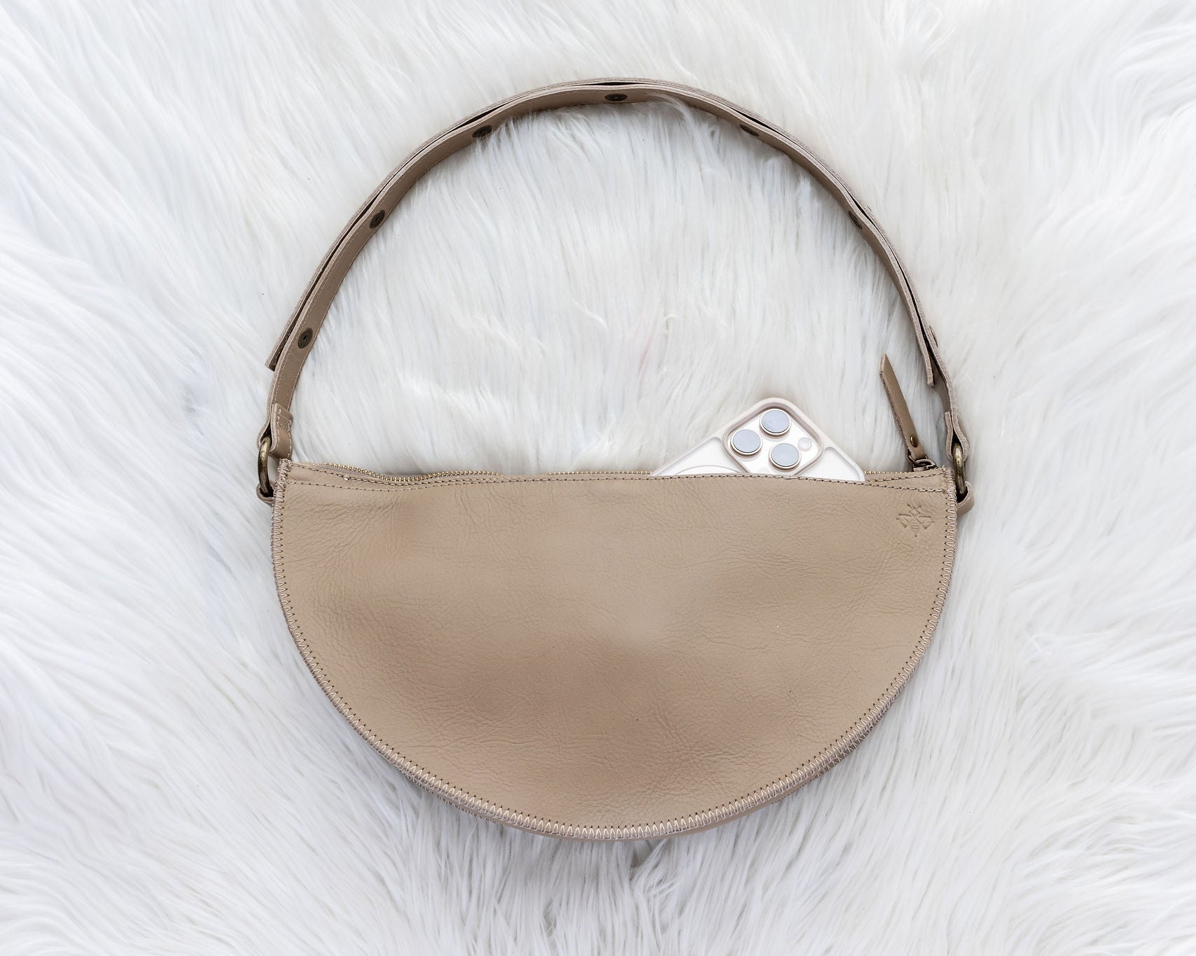 Beige handbag on a white fur surface