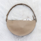 Beige handbag on a white fur surface
