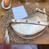 Table setting with wine glasses, bread, and decorative elements on a wooden table.