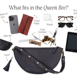 Black crossbody bag with items it can hold on a white background