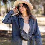 Woman wearing a blue denim jacket and beige hat outdoors