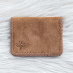Brown leather cardholder on a white textured background