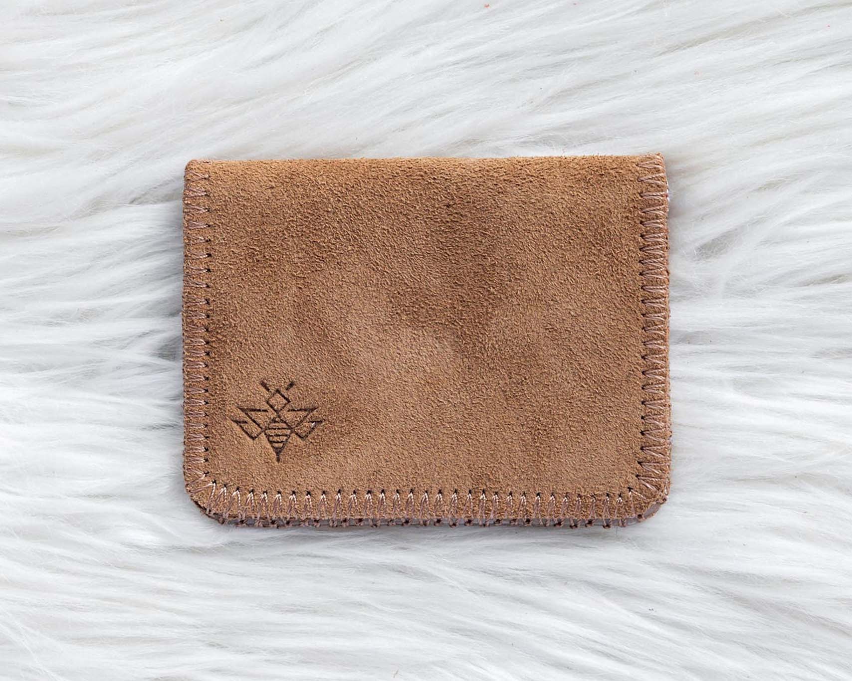 Brown leather cardholder on a white textured background