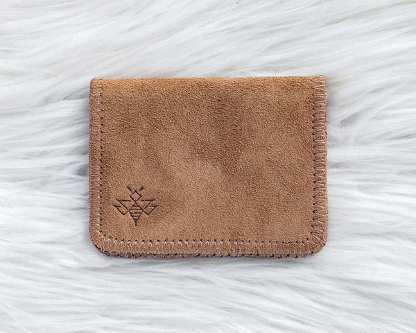 Brown leather cardholder on a white textured background