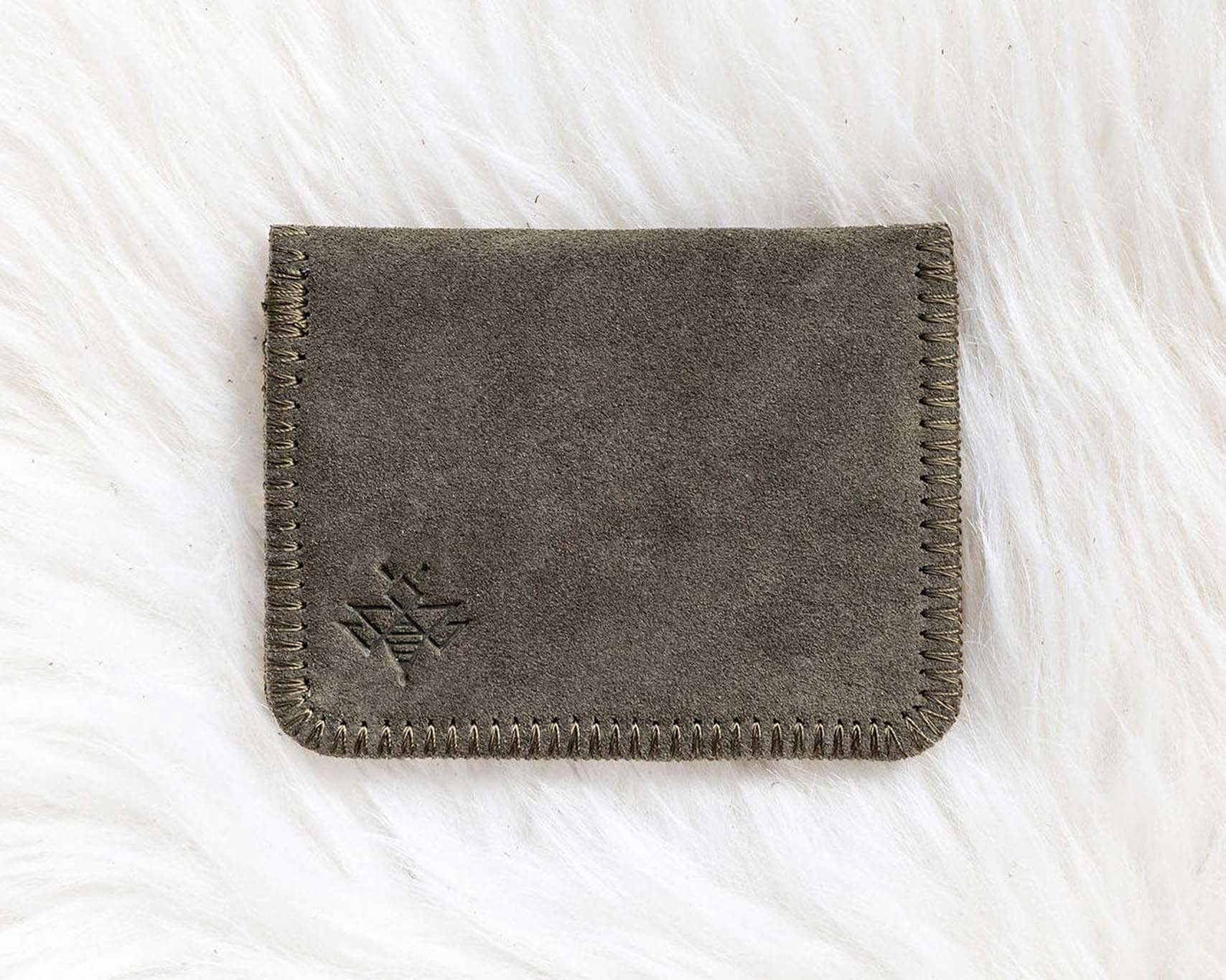 Gray fabric wallet on a white textured surface