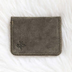 Gray fabric wallet on a white textured surface