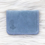 Blue fabric cardholder on a white textured background