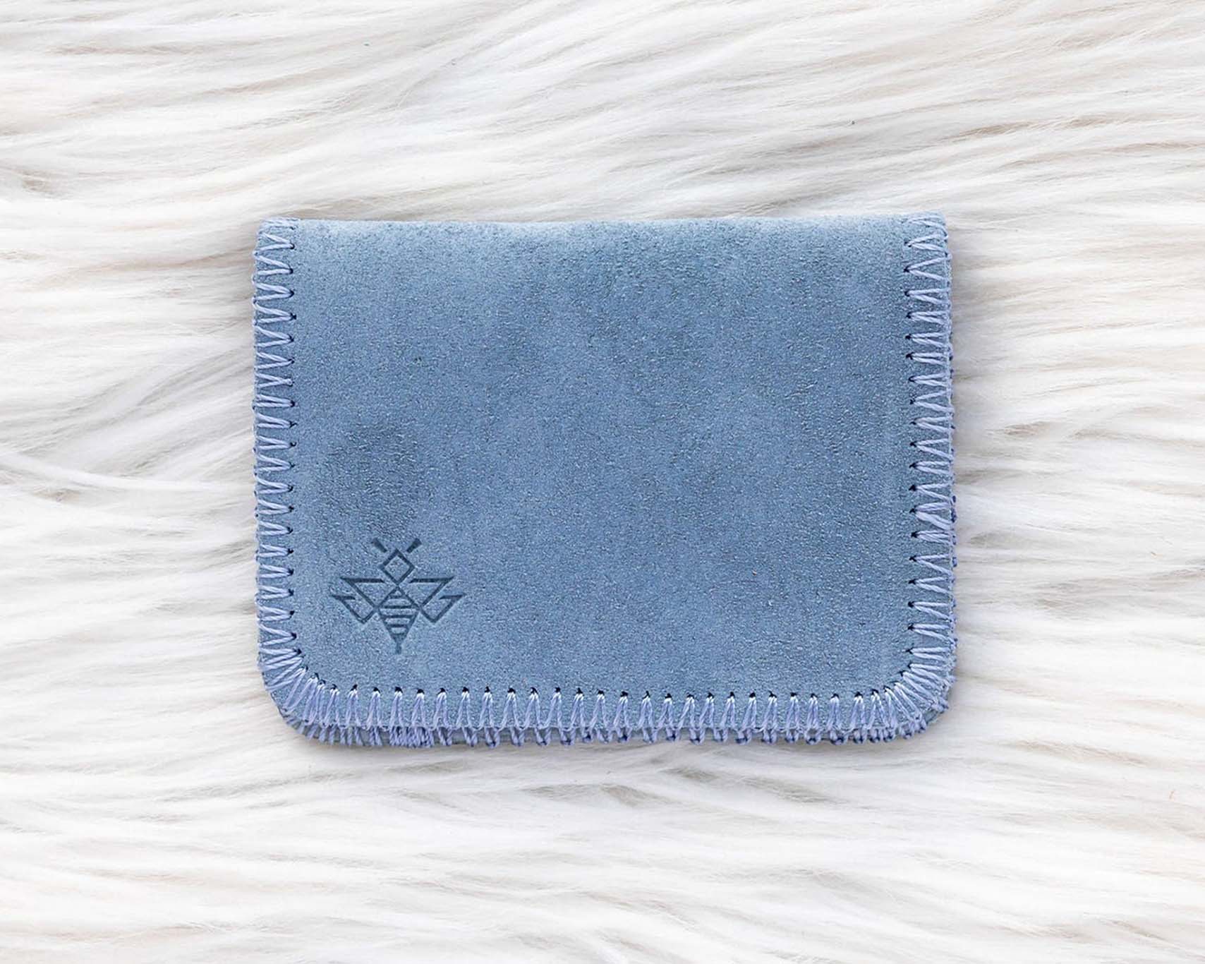 Blue fabric cardholder on a white textured background