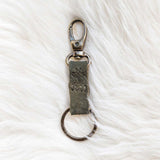 Keychain with a metal clasp on a white textured background