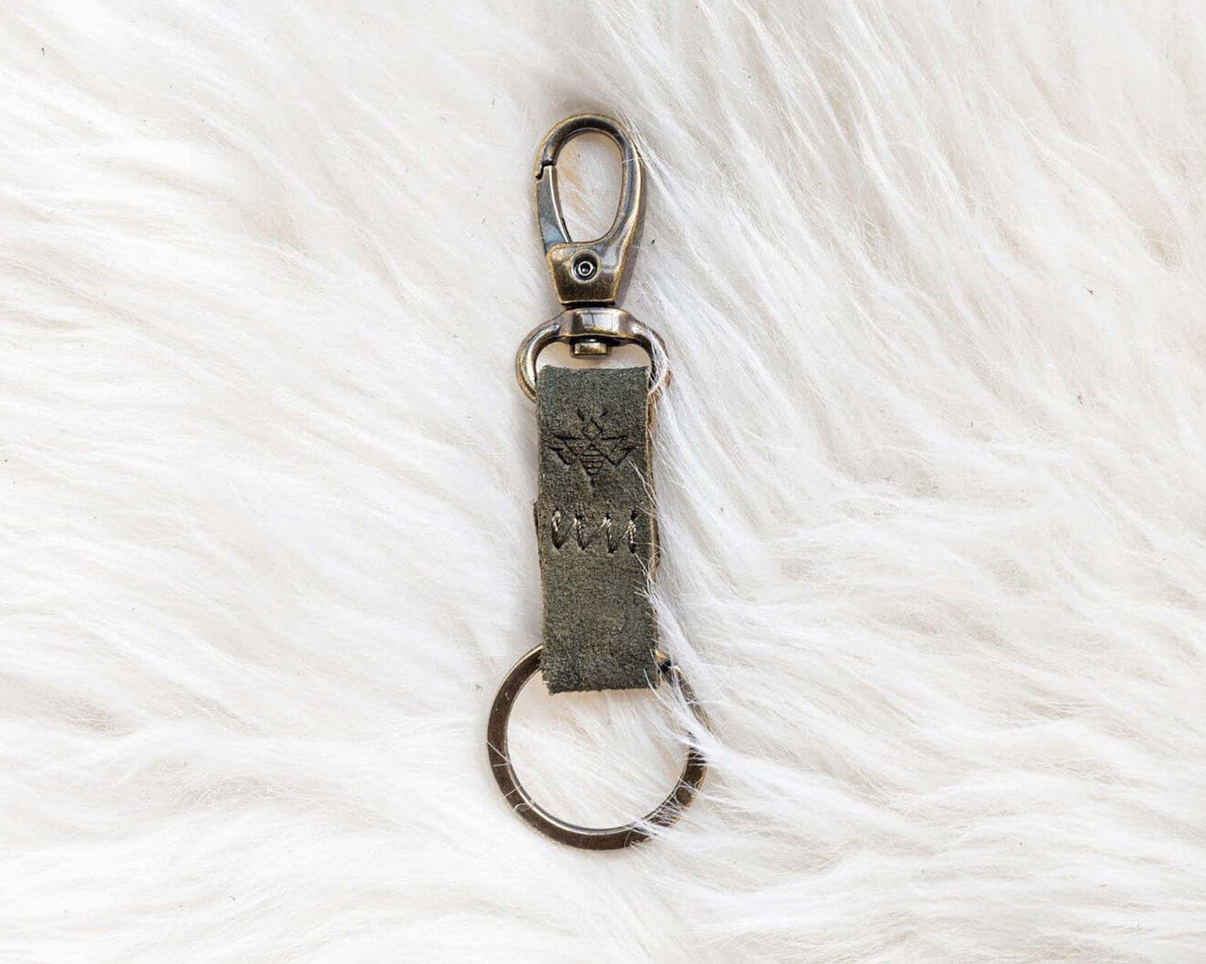 Keychain with a metal clasp on a white textured background