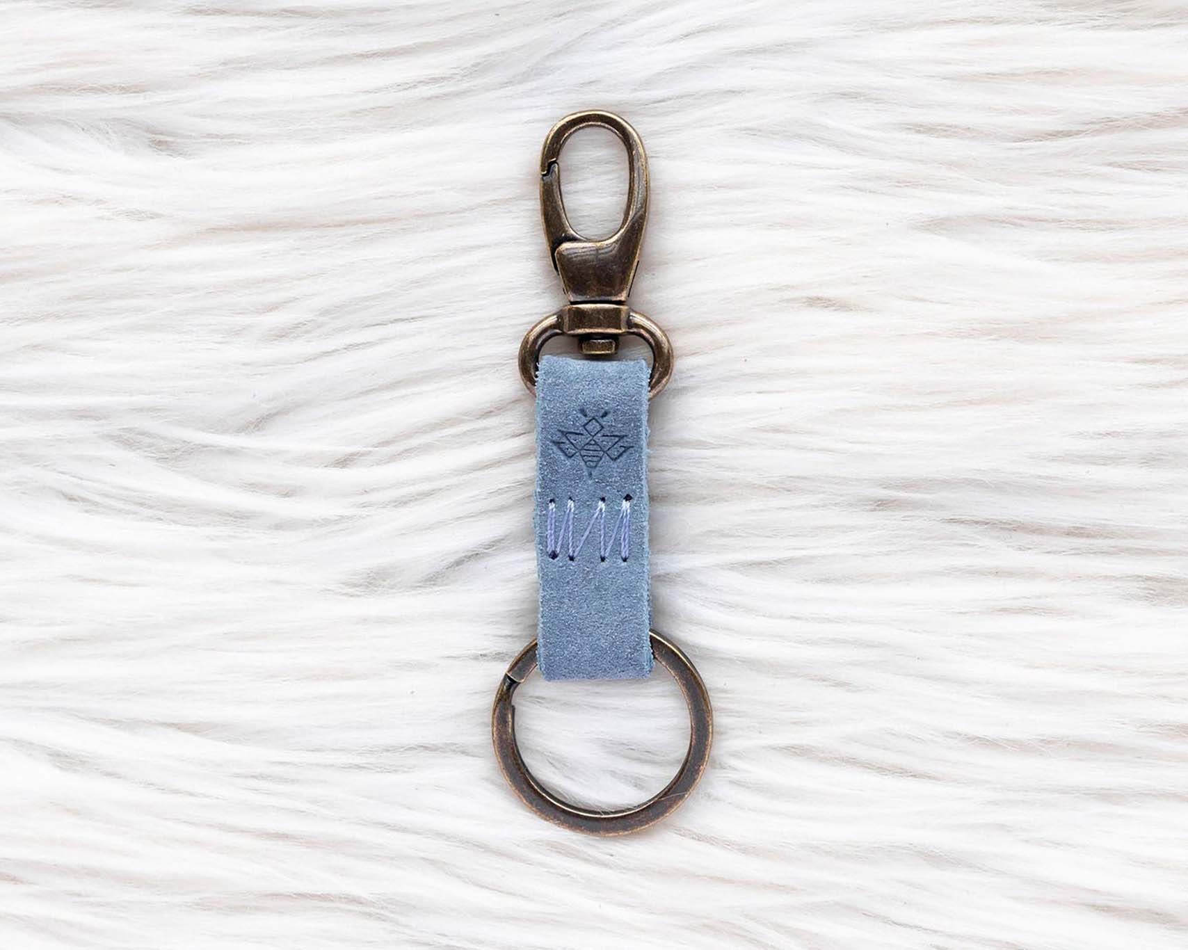 Keychain with a blue tag on a white textured background