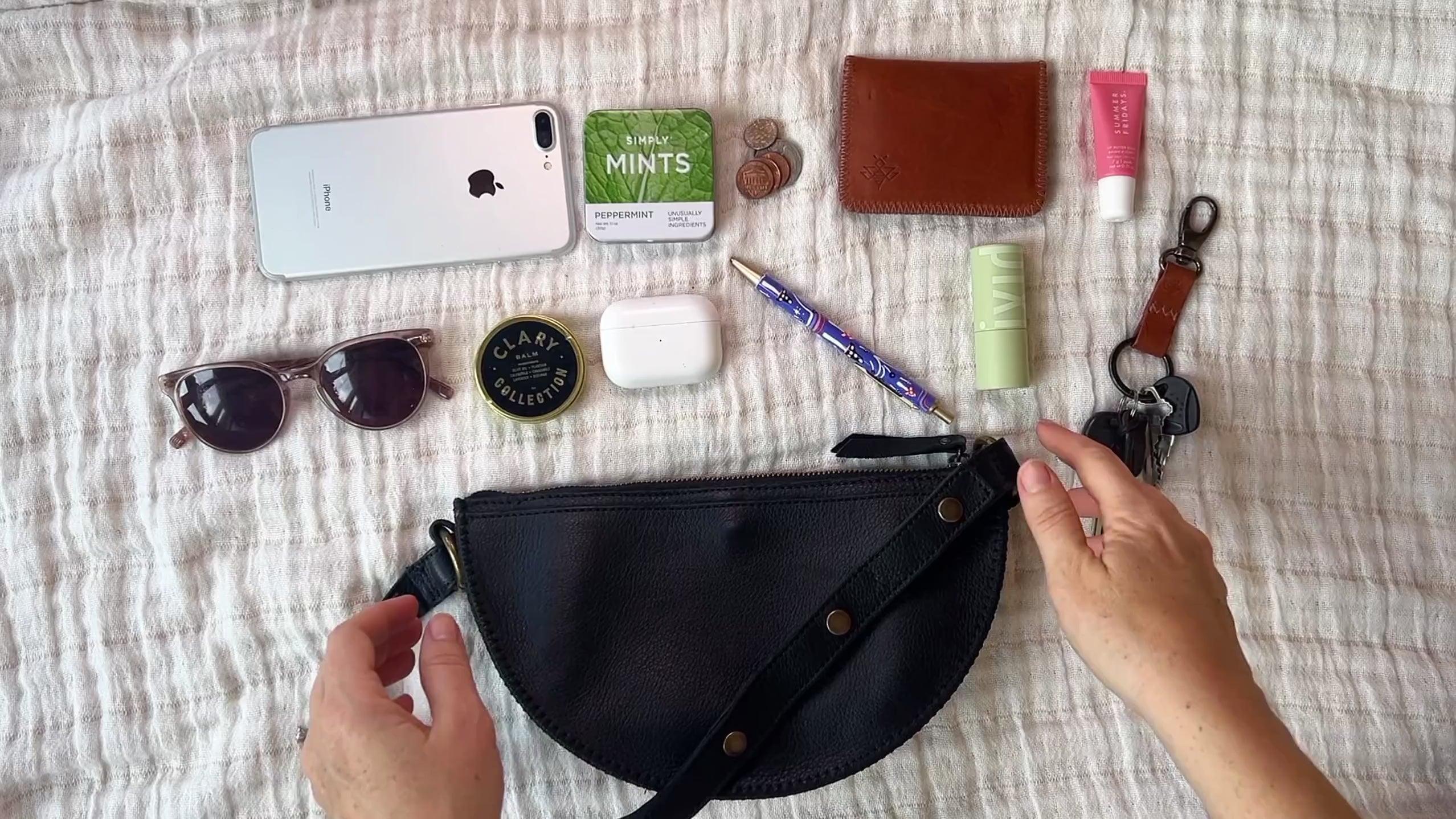 Small black leather pouch packing video