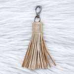 Tassel keychain on a textured white surface