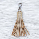 Tassel keychain on a textured white surface