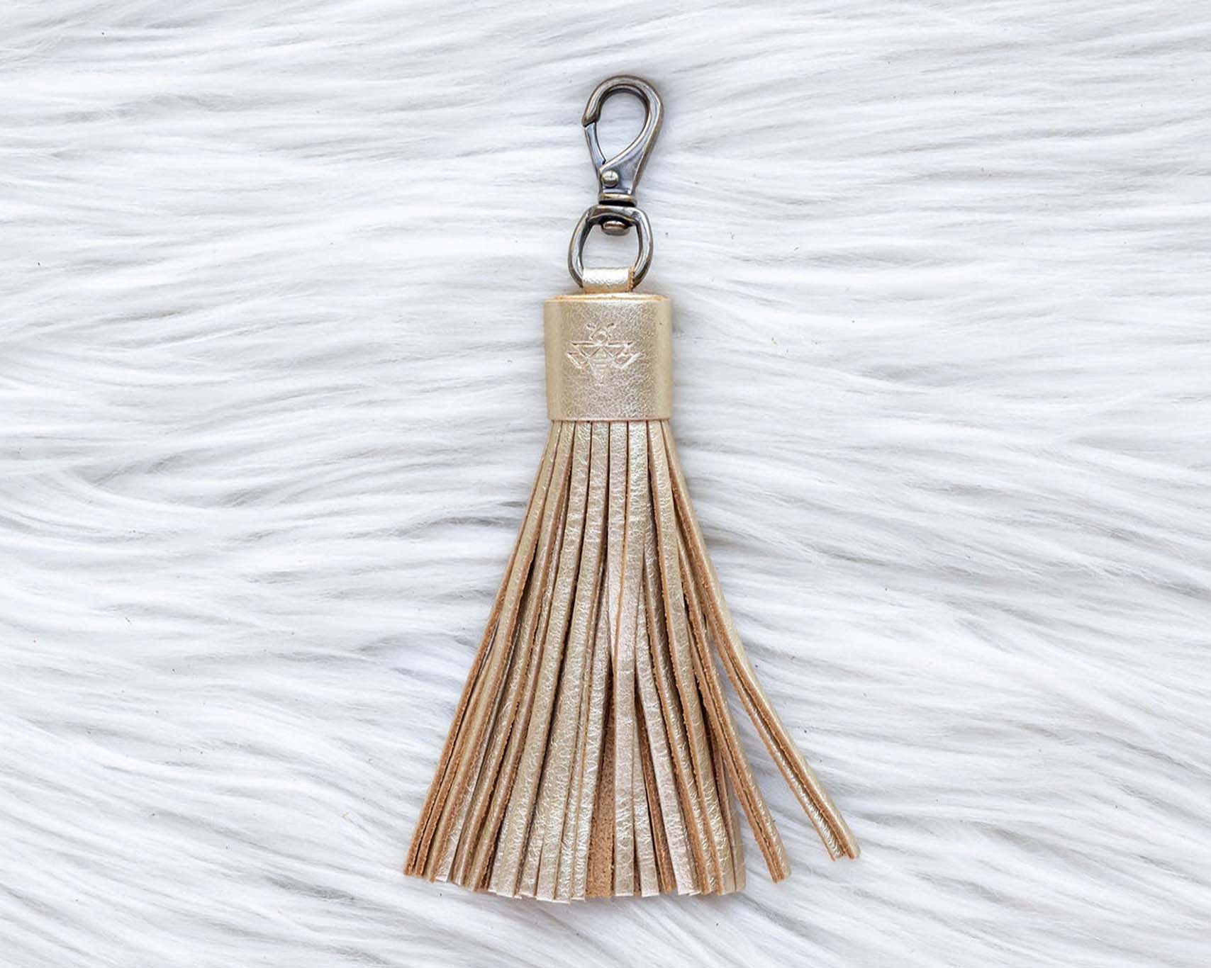 Tassel keychain on a textured white surface