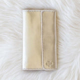 Beige wallet on a white fur surface