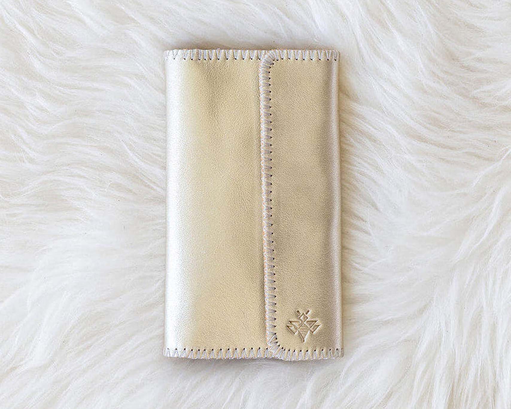 Beige wallet on a white fur surface