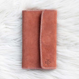 Folded pink blanket on a textured white surface