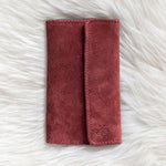 Red fabric pouch on a white fluffy surface