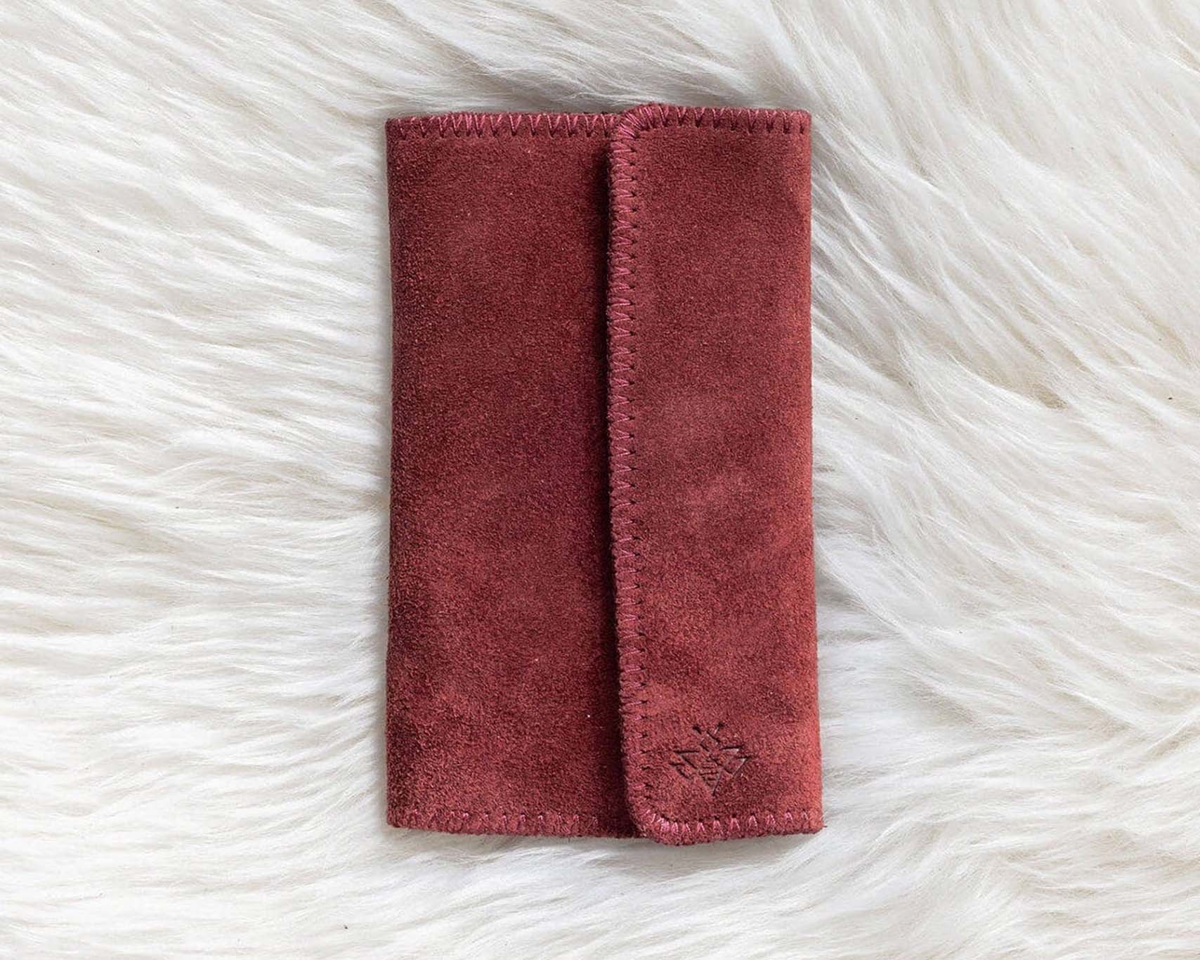 Red fabric pouch on a white fluffy surface